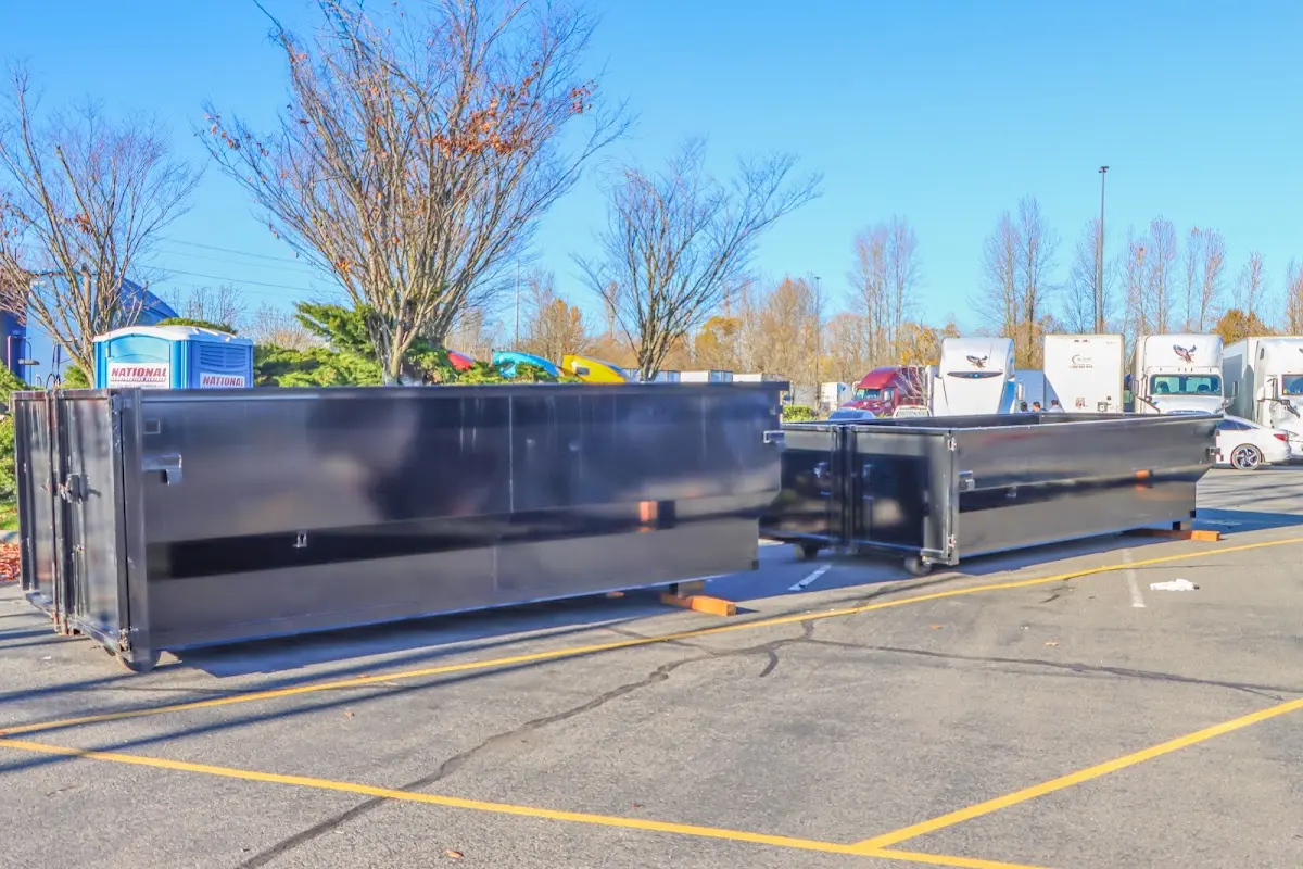 Professional dumpster rental service with roll-off container on residential driveway in Glastonbury
